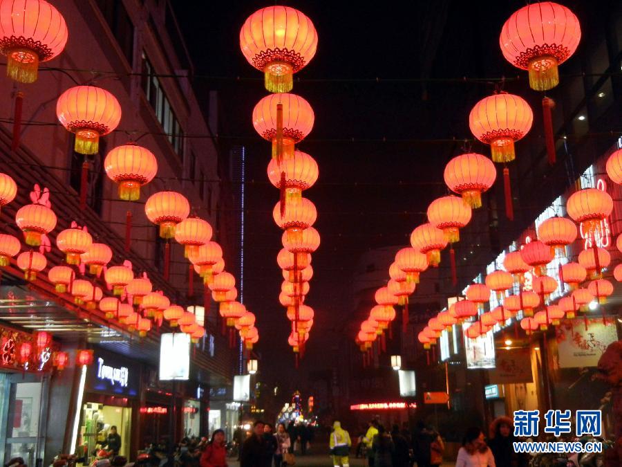 　1月30日，市民行走在大红灯笼装饰的苏州街头。