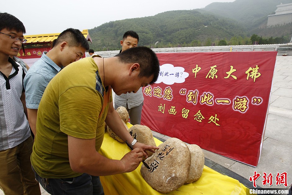 中原大佛欢迎游客刻画“到此一游”留念