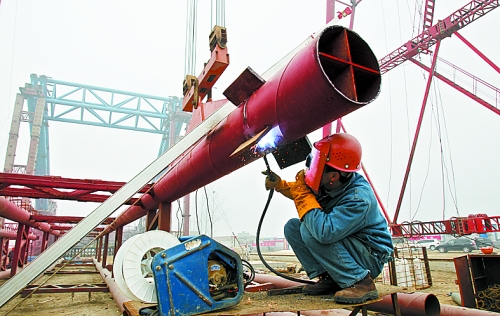 2月25日，在跨越南水北调总干渠的郑州新郑南段十里铺公路桥施工现场，建设者在紧张地施工。